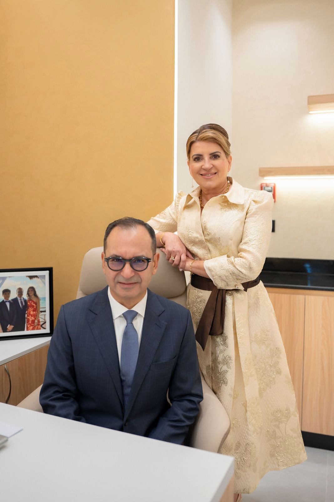 Two people photographed in an office at AAMC Polyclinic.